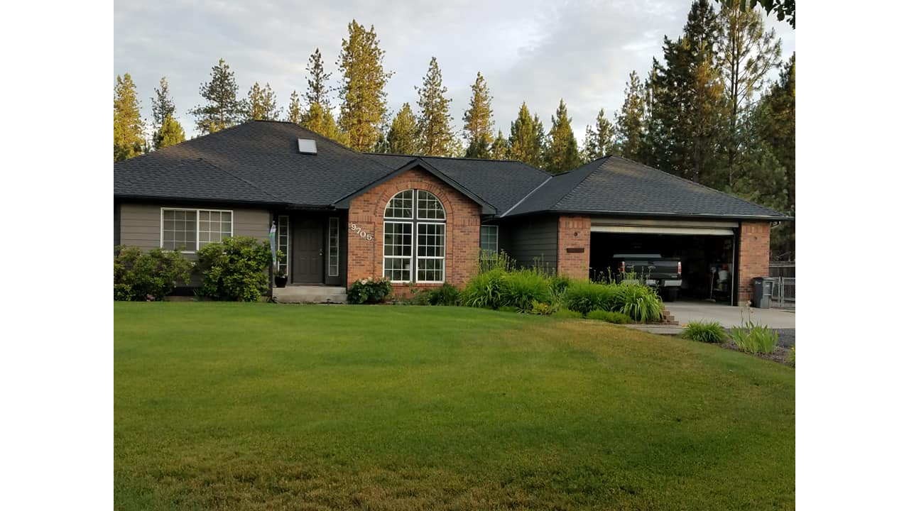 Recently completed dark shingle roof replacement on a Spokane home