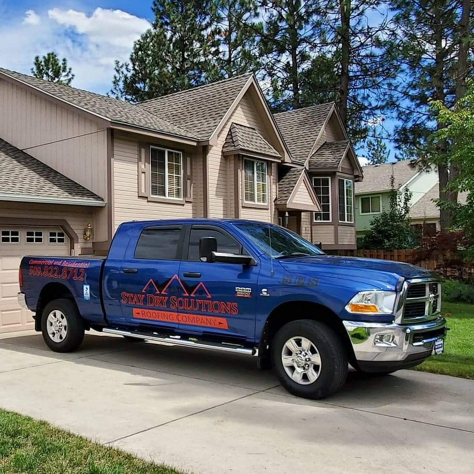 Stay Dry Solutions branded truck parked outside a Spokane home