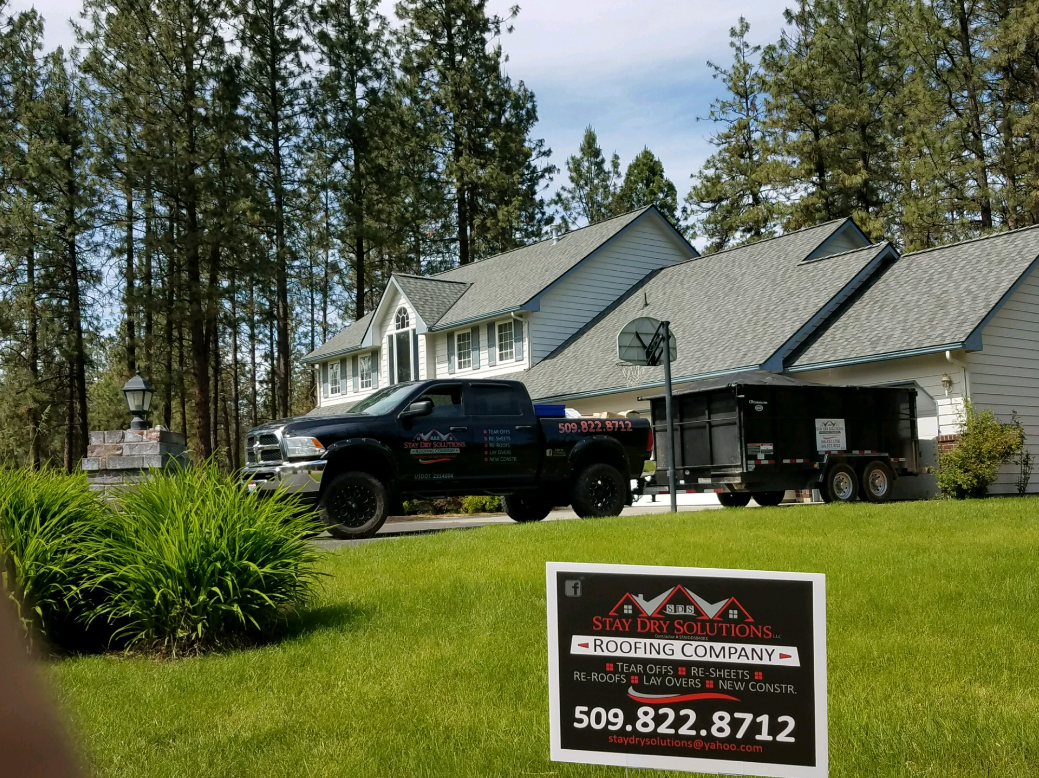 Stay Dry Solutions truck and job sign at a roofing project in Spokane